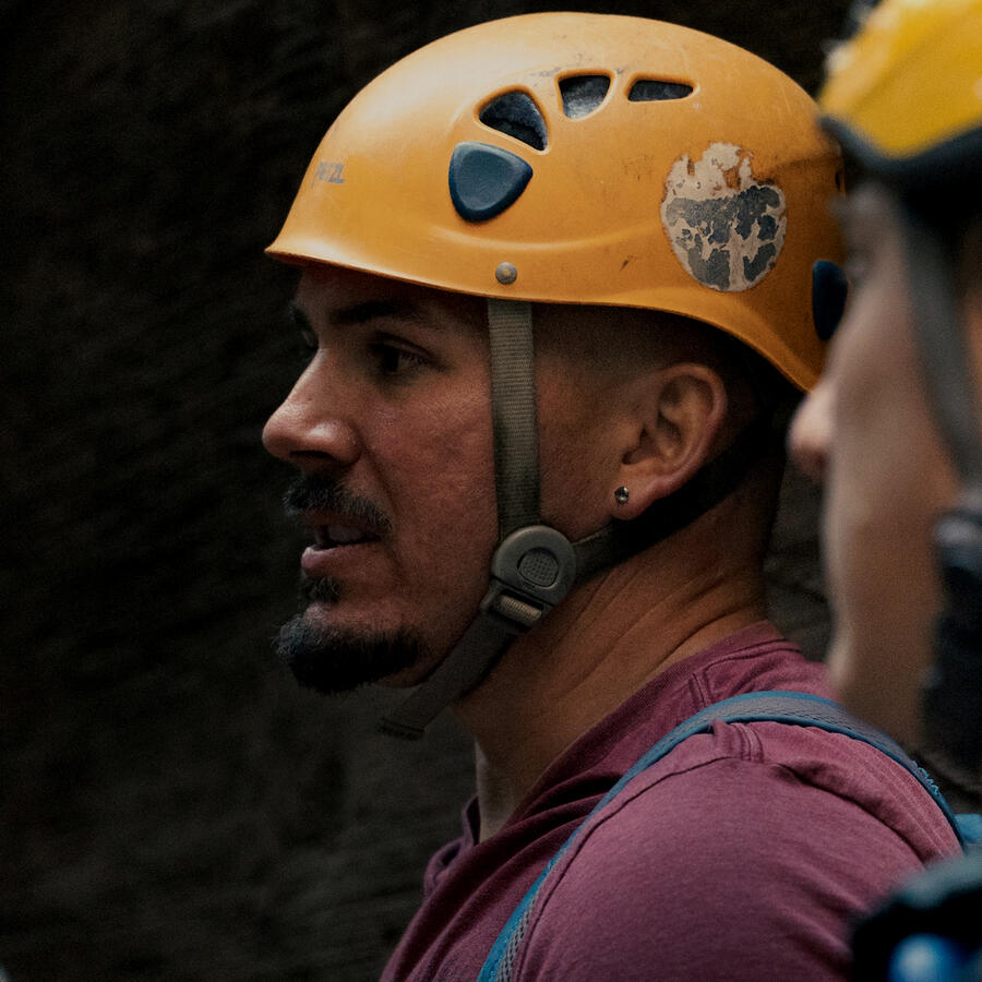 Mormon man seeking a way to belong while remaining authentic. Image of a man with a canyoneering helmet looking outward, conveying a desire to be seen and to fit in to a Church culture that is not always inclusive.
